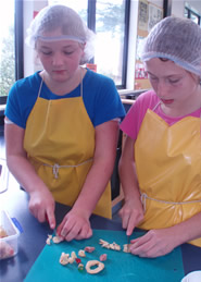 Students cutting dehydrated apples and fruits for the nuggets mixture