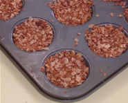 The finished nuggets in a muffin tin, ready to be baked