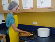 Student weighing apple slices on scales