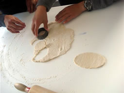 Students cutting dough