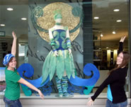 Ellen and Megan at the Te Papa store with their dress displayed in the window