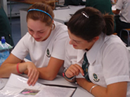 Two Year 11 students looking over work