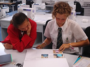 Two Year 11 students looking over work