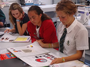 Three Year 11 students looking over work