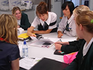 A Year 12 student explains work to a group of younger students