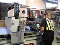 Cutting and drilling of the panels is done automatically by computer-controlled cutters on a large flat-bed machine.