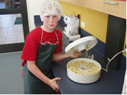 Student with dehydrator containing apples