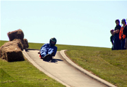 A student riding his luge down the track