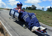 A student riding his luge down the track