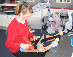 Student weaving on a loom